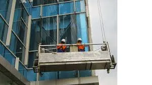 Alat gondola gedung digunakan oleh pekerja untuk membersihkan kaca